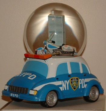 NYPD Snow Globe - NYPD Snow Globe atop a partol car, featuring the Twin Towers inside the globe